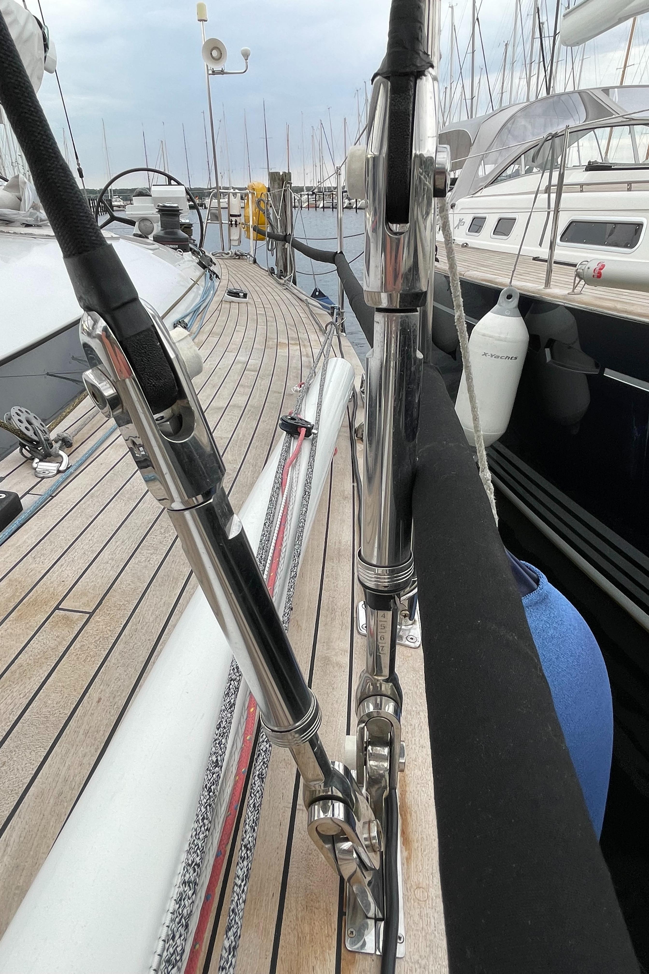 Deck view of a 2005 Comet 45 S sailboat, showcasing rigging and marina background.