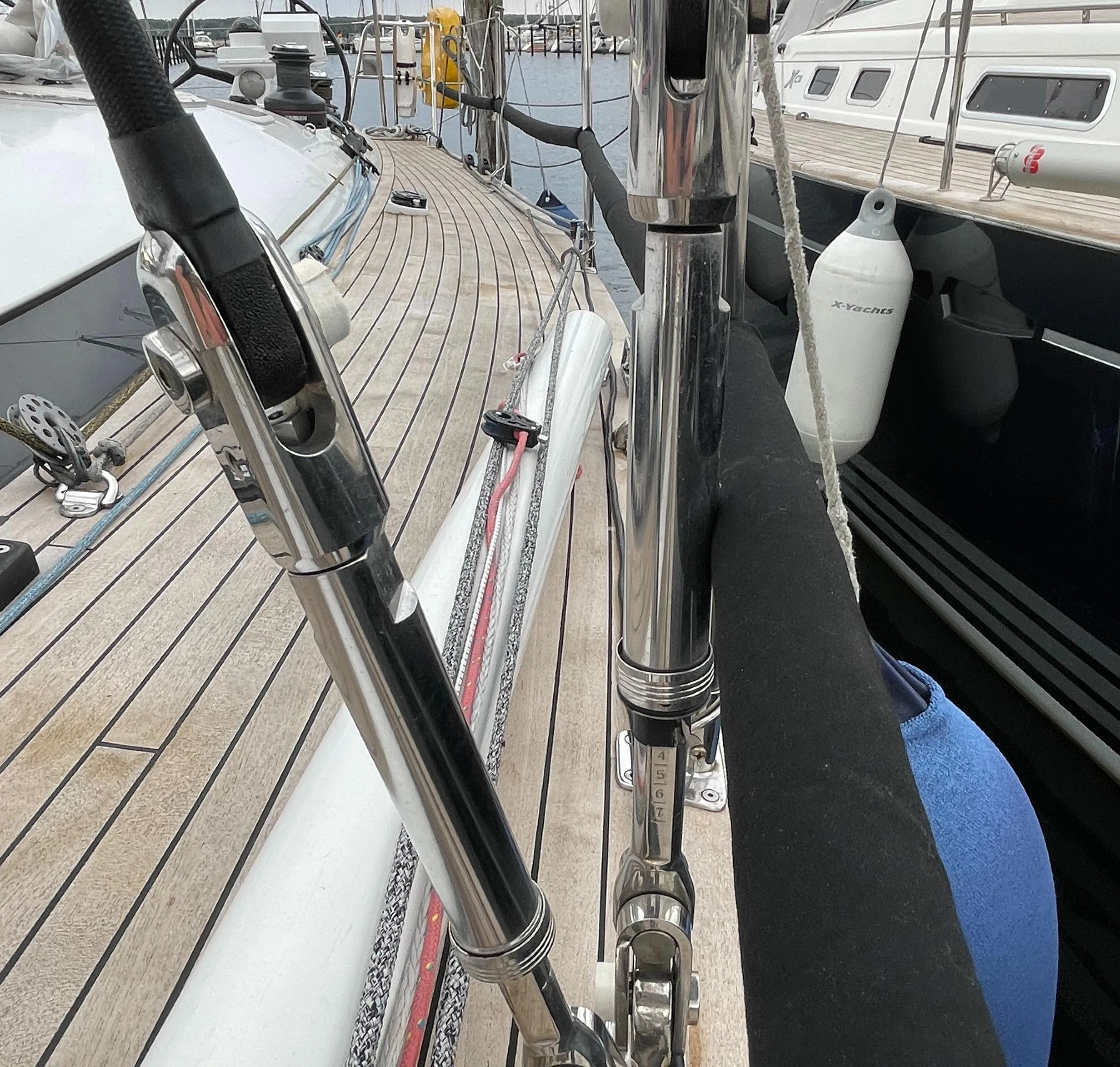 Deck view of a 2005 Comet 45 S sailboat, showcasing rigging and marina background.