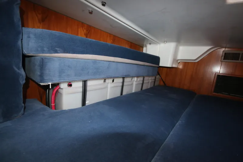 Exfil Yacht Photos Pics Interior view of 1998 Beneteau Oceanis 461 sailboat with blue cushioned seating.