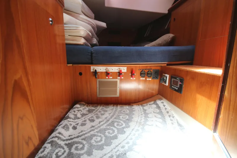 Exfil Yacht Photos Pics Interior of 1998 Beneteau Oceanis 461 yacht with wooden paneling and control switches.