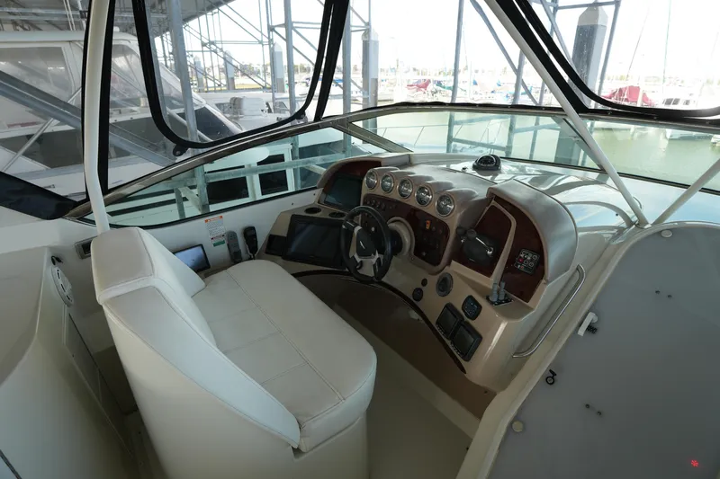 So Far Yacht Photos Pics 2004 Carver 560 Voyager helm with modern controls and leather seating.