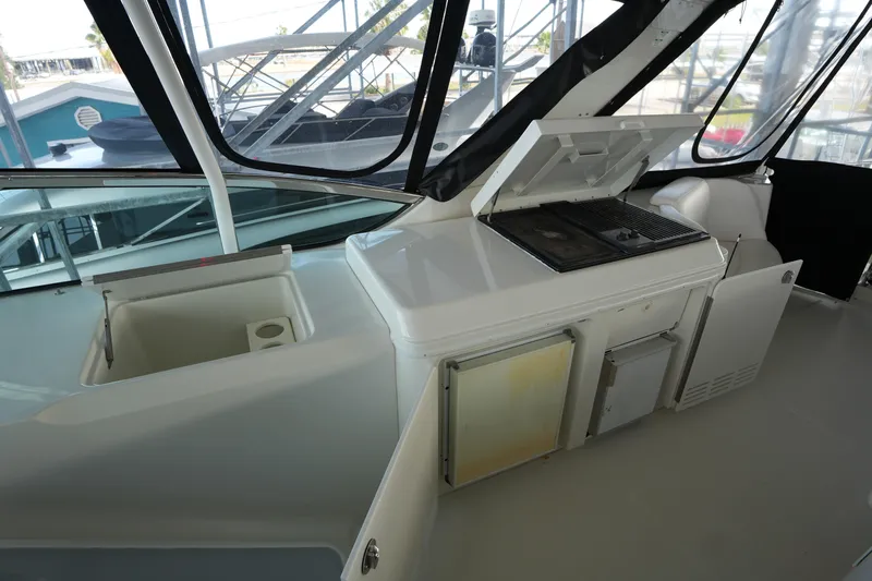 So Far Yacht Photos Pics 2004 Carver 560 Voyager yacht interior with kitchenette and grill area.
