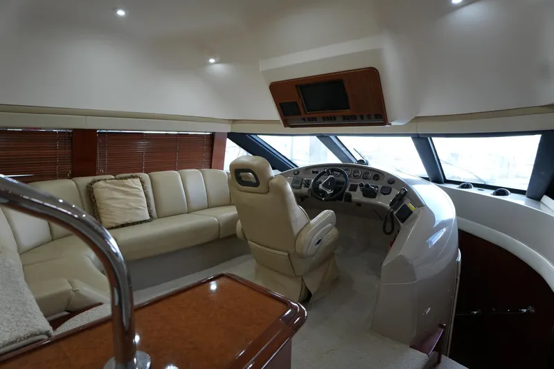 So Far Yacht Photos Pics Luxurious interior of a 2004 Carver 560 Voyager yacht with plush seating and modern helm.