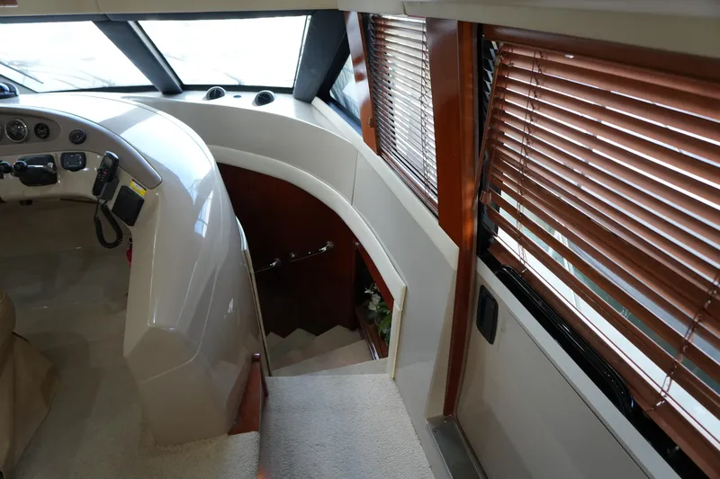 So Far Yacht Photos Pics Interior of 2004 Carver 560 Voyager yacht with helm and wooden blinds.