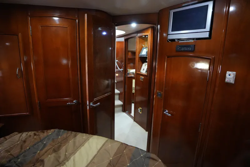 So Far Yacht Photos Pics Luxurious interior of 2004 Carver 560 Voyager yacht with wood paneling and built-in TV.