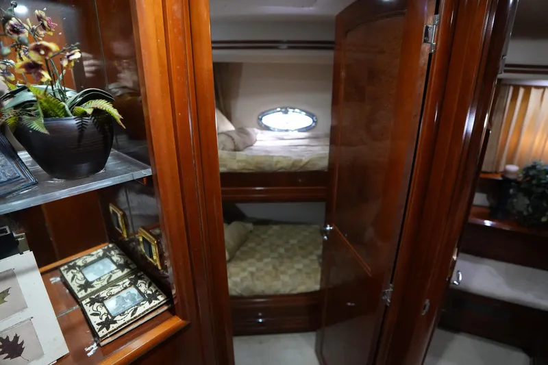 So Far Yacht Photos Pics Luxurious interior of 2004 Carver 560 Voyager yacht with wooden cabinetry and cozy bunk beds.