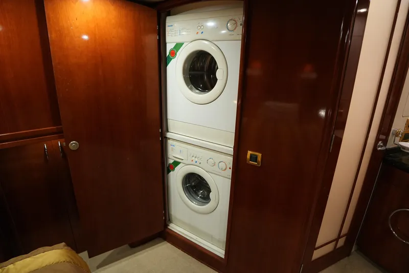 So Far Yacht Photos Pics Stacked washer and dryer in 2004 Carver 560 Voyager yacht's wooden interior.