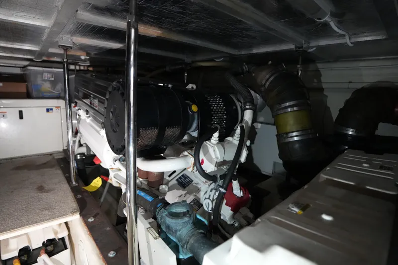 So Far Yacht Photos Pics Engine room of a 2004 Carver 560 Voyager yacht, showcasing mechanical components.
