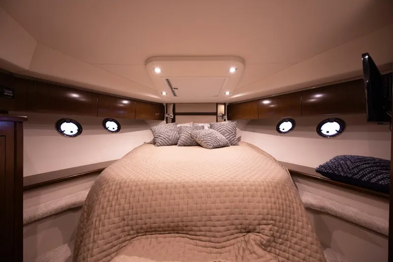 Epic Yacht Photos Pics Luxurious cabin interior of 2013 Cruisers Yachts 540 Sports Coupe with cozy bedding.