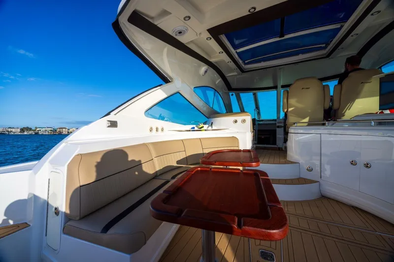 Epic Yacht Photos Pics 2013 Cruisers Yachts 540 Sports Coupe interior with seating and ocean view.