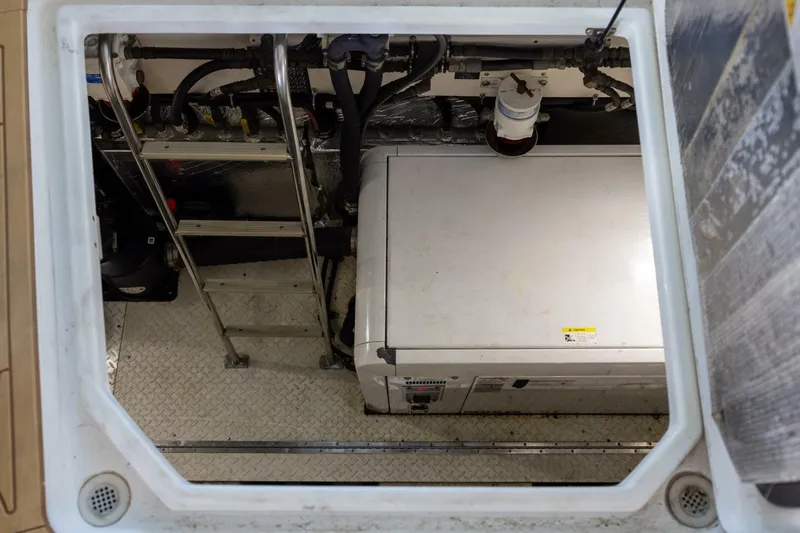 Epic Yacht Photos Pics Engine compartment of 2013 Cruisers Yachts 540 Sports Coupe with visible machinery and ladder.