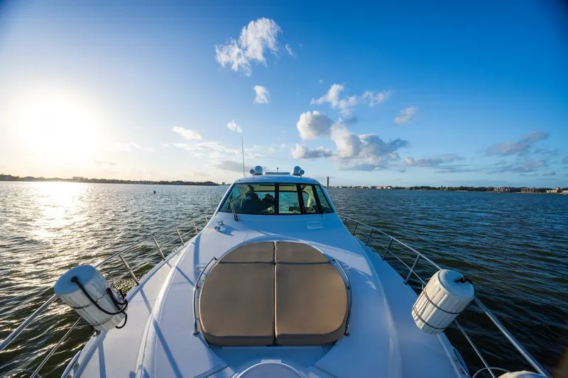 Epic Yacht Photos Pics 2013 Cruisers Yachts 540 Sports Coupe on serene water at sunset.