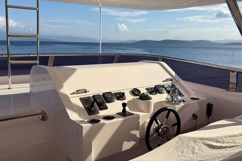 Elza Of London Yacht Photos Pics Luxury yacht helm on 2015 Majesty 122, overlooking serene ocean and distant islands.