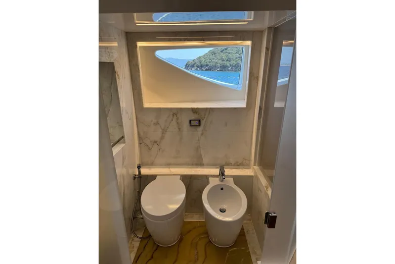 Elza Of London Yacht Photos Pics Luxurious yacht bathroom with marble decor, featuring a toilet and bidet, Majesty 122, 2015 model.