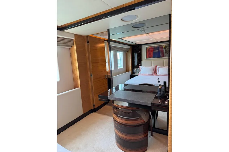 Elza Of London Yacht Photos Pics Luxurious bedroom interior on 2015 Majesty 122 yacht, featuring elegant wood finishes and modern decor.