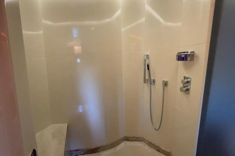 Elza Of London Yacht Photos Pics Luxurious shower area in a 2015 Majesty 122 yacht, featuring modern fixtures and sleek design.