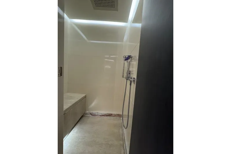 Elza Of London Yacht Photos Pics Luxurious shower area in 2015 Majesty 122 yacht, featuring modern fixtures and seating.