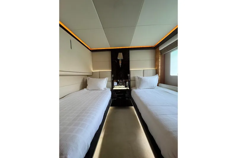 Elza Of London Yacht Photos Pics Luxurious twin bedroom on 2015 Majesty 122 yacht, featuring elegant design and ambient lighting.