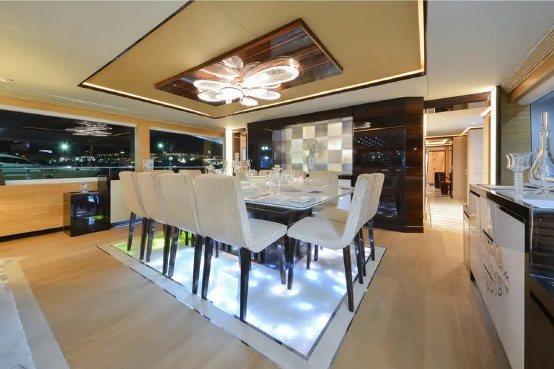 Elza Of London Yacht Photos Pics Luxurious dining area on 2015 Majesty 122 yacht, featuring elegant decor and ambient lighting.