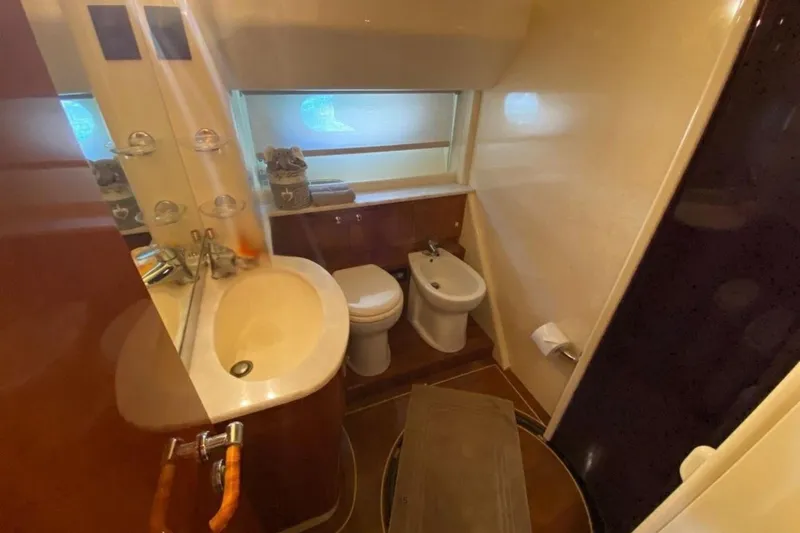 M/y Okiyo Yacht Photos Pics Luxurious bathroom in 2002 Ferretti Yachts 68, featuring sink, toilet, and bidet.
