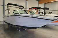 2019 MasterCraft NXT22 boat in showroom, sleek design, black canopy, modern features.