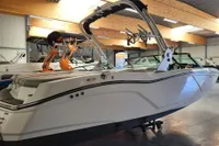 2019 MasterCraft NXT22 boat in showroom, featuring sleek design and modern wakeboard tower.