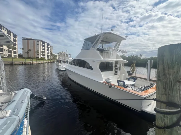 Fender Bender Yacht Photos Pics 1996 Ocean Yachts 48 Super Sport docked in a marina under a partly cloudy sky.