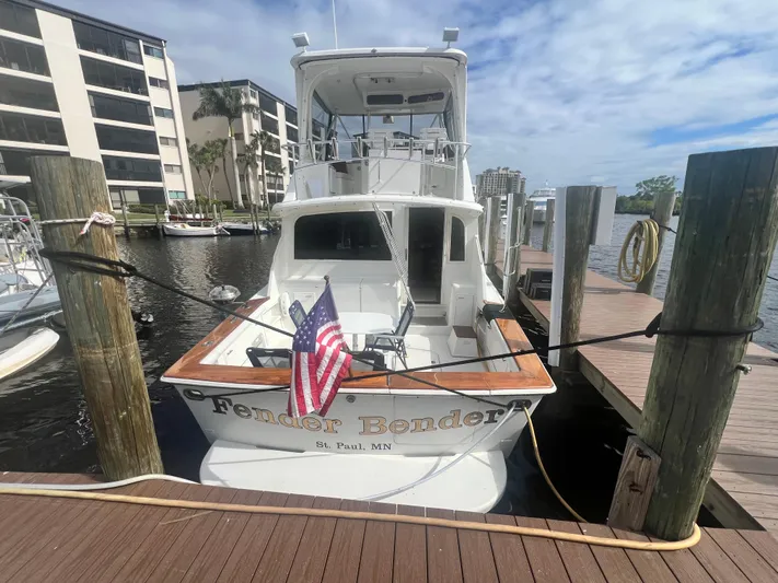 Fender Bender Yacht Photos Pics Ocean Yachts 1996 48 Super Sport docked, displaying American flag, sunny day.