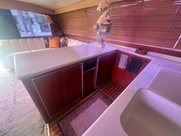 Fender Bender Yacht Photos Pics Interior of 1996 Ocean Yachts 48 Super Sport with modern kitchen and seating area.