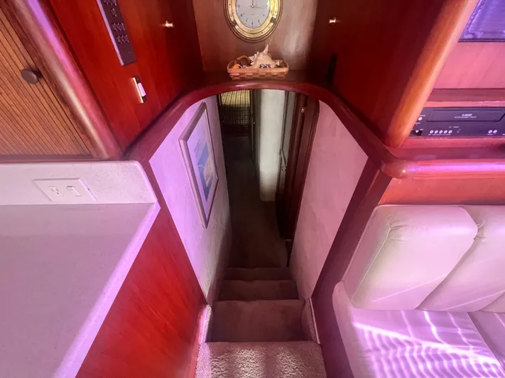 Fender Bender Yacht Photos Pics Interior view of 1996 Ocean Yachts 48 Super Sport, featuring wooden cabinetry and carpeted stairs.