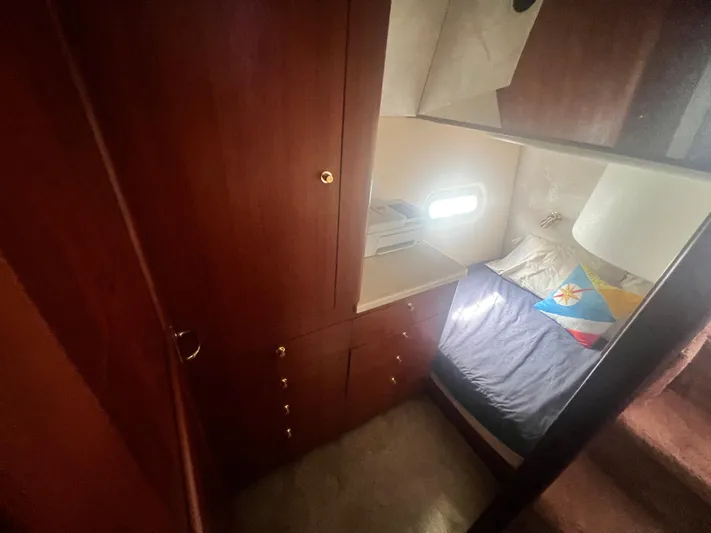 Fender Bender Yacht Photos Pics Interior cabin of 1996 Ocean Yachts 48 Super Sport with wooden cabinetry and cozy bed.