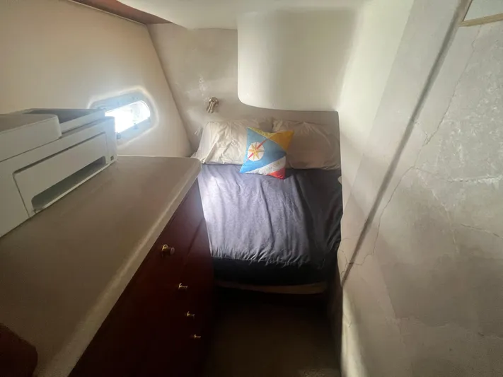 Fender Bender Yacht Photos Pics 1996 Ocean Yachts 48 Super Sport cabin with bed, window, and storage drawers.