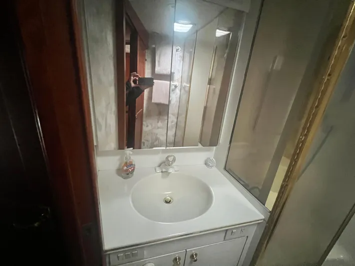 Fender Bender Yacht Photos Pics Bathroom vanity in 1996 Ocean Yachts 48 Super Sport, featuring a sink and mirrored cabinet.