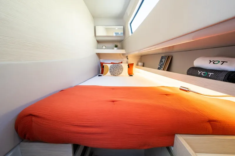  Yacht Photos Pics Modern YOT 36 yacht cabin with orange bedding, sleek design, and ambient lighting, 2025 model.