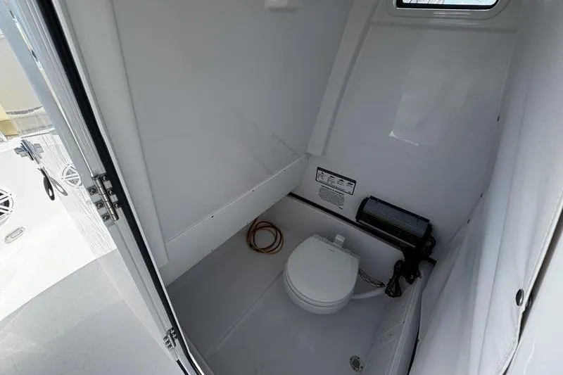  Yacht Photos Pics 2026 Sportsman Open 252 Center Console boat interior with compact marine toilet.