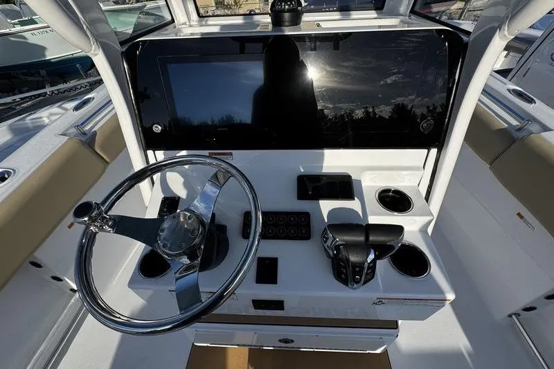  Yacht Photos Pics 2026 Sportsman Open 252 Center Console boat dashboard with steering wheel and controls.