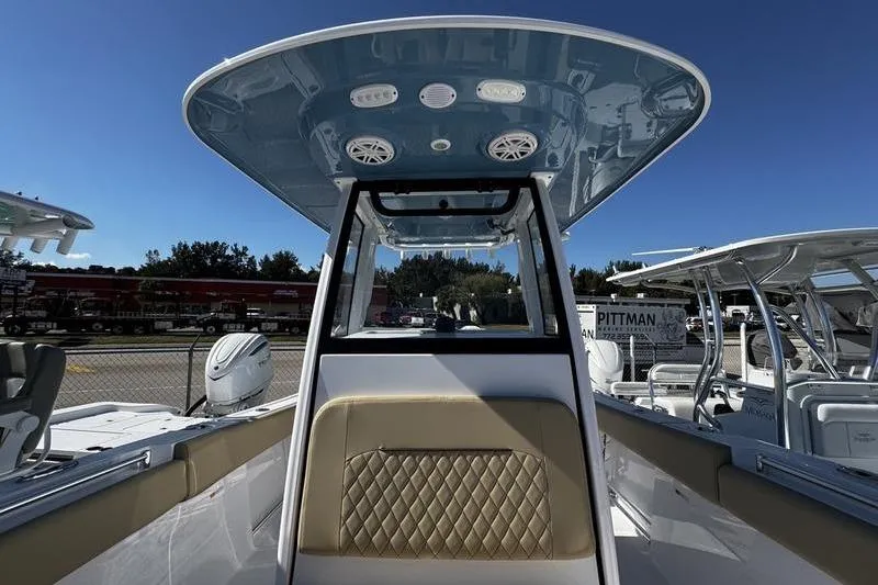  Yacht Photos Pics 2026 Sportsman Open 252 Center Console boat with blue T-top and beige seating.