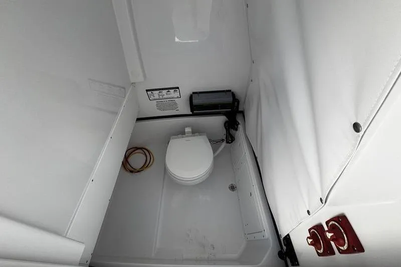  Yacht Photos Pics 2026 Sportsman Open 252 Center Console boat interior with compact marine toilet.