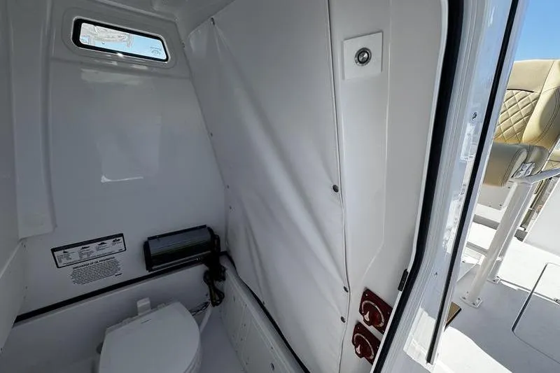  Yacht Photos Pics 2026 Sportsman Open 252 Center Console boat interior with compact restroom.