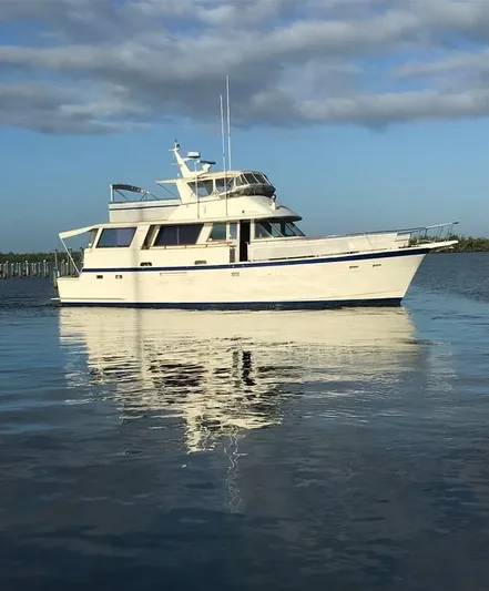 The Entertainer Yacht Photos Pics 1984 Hatteras 61 Cockpit MY yacht on calm water under blue sky.