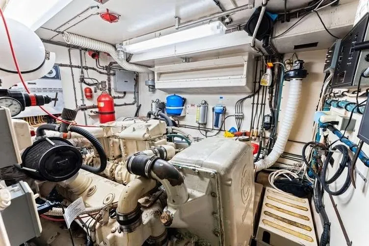 The Entertainer Yacht Photos Pics Engine room of 1984 Hatteras 61 Cockpit MY, featuring complex machinery and equipment.