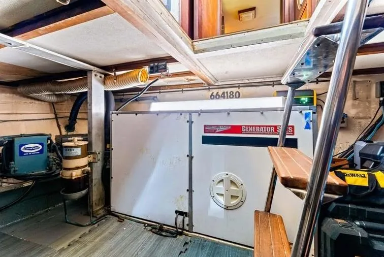 The Entertainer Yacht Photos Pics Engine room of 1984 Hatteras 61 Cockpit MY, featuring generator and equipment.