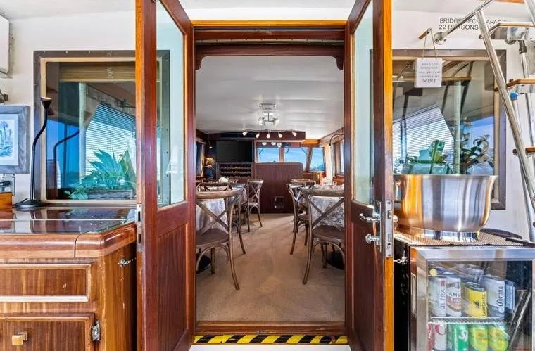 The Entertainer Yacht Photos Pics Interior view of 1984 Hatteras 61 Cockpit MY yacht, featuring elegant dining area.