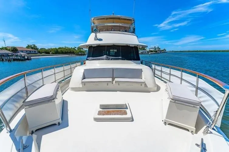 The Entertainer Yacht Photos Pics 1984 Hatteras 61 Cockpit MY yacht on calm water, featuring spacious deck and seating.