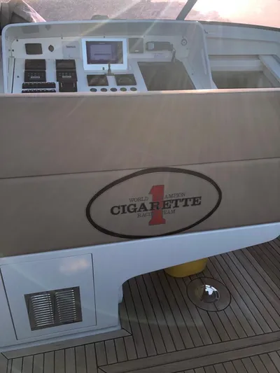  Yacht Photos Pics 1997 Otam 45 yacht cockpit with control panel and Cigarette Racing Team logo.