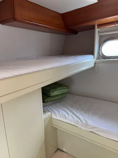  Yacht Photos Pics Interior of 1997 Otam 45 yacht with bunk beds and porthole window.
