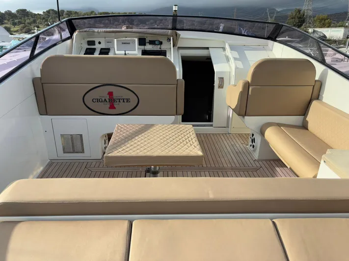  Yacht Photos Pics 1997 Otam 45 yacht interior with beige seating and control panel.