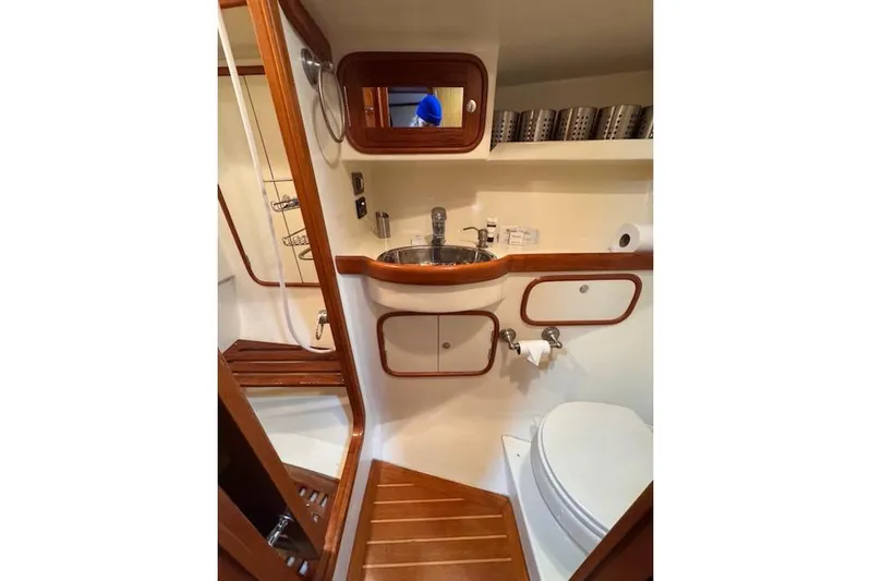 "fast Water" Yacht Photos Pics 2006 Tayana Deck Salon yacht bathroom with wooden accents and modern fixtures.