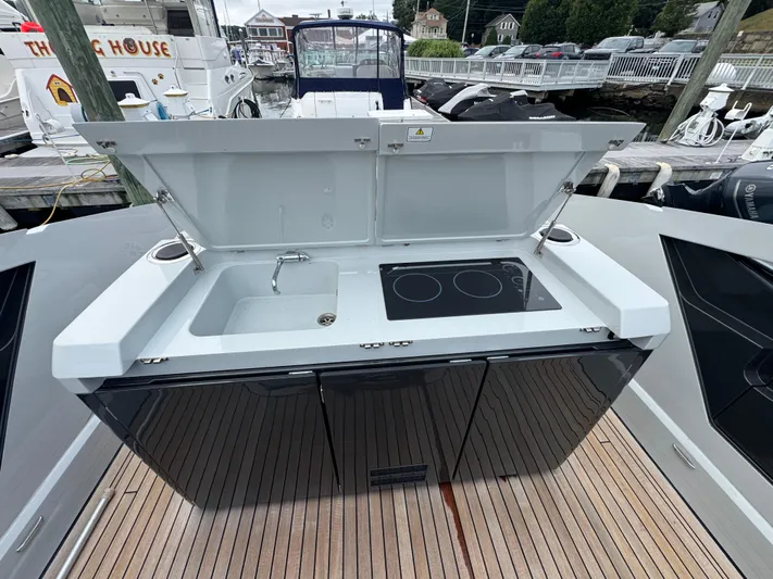  Yacht Photos Pics Outdoor kitchen on 2021 Fairline F//Line 33 yacht with sink and stove.