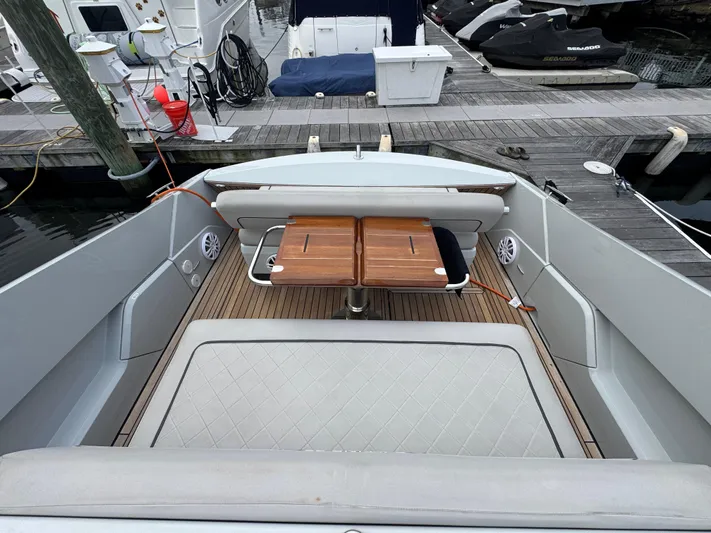  Yacht Photos Pics 2021 Fairline F//Line 33 yacht interior with wooden table and cushioned seating.